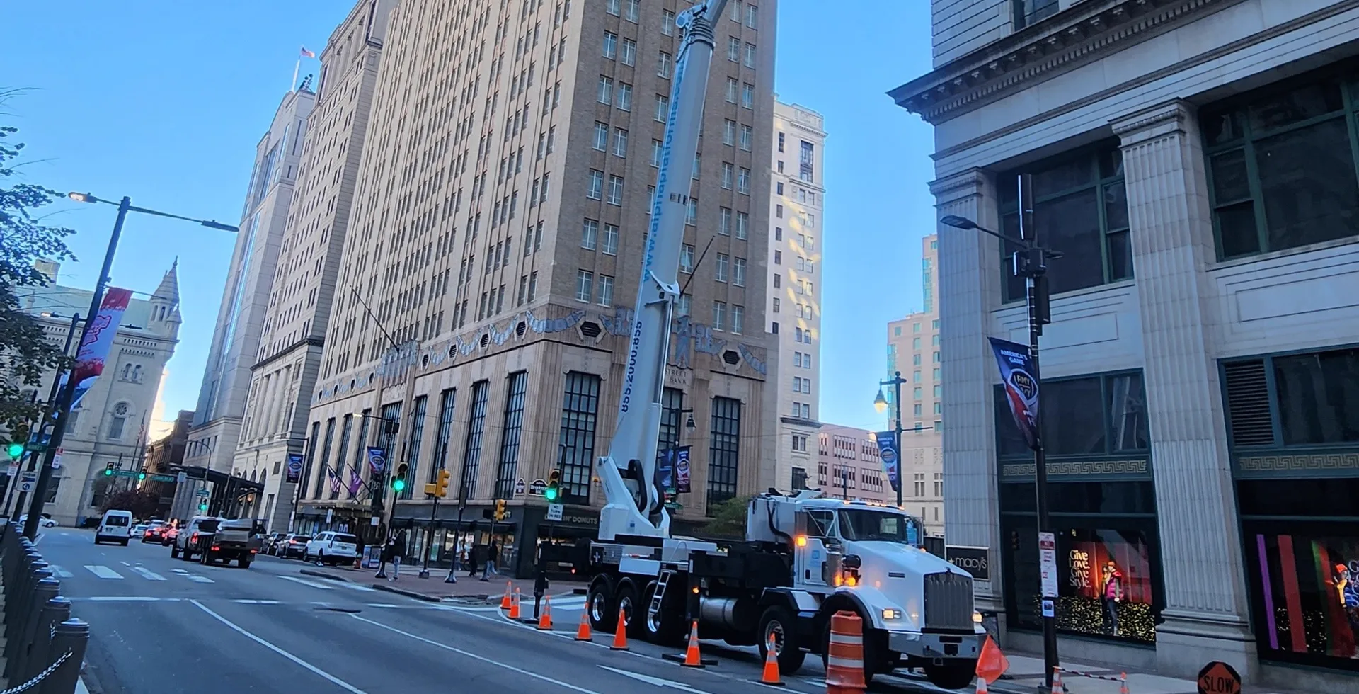 Boom lift inspecting a landmark building facade from the street